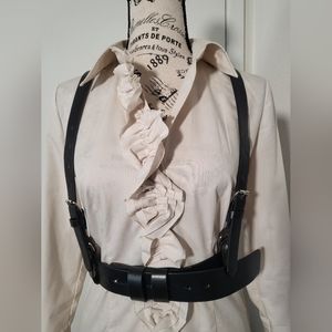 Black harness,faux leather, adjustable around the waist and on the straps.